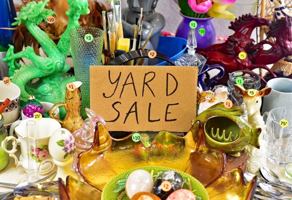 yard sale sign with item priced on a garage table